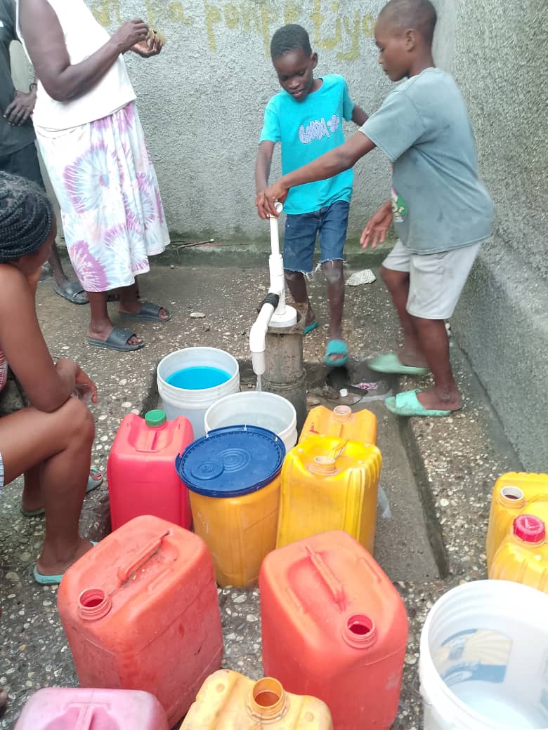A community water well in Haiti, painted &lsquo;Thank You Positive Ripples.&rsquo;